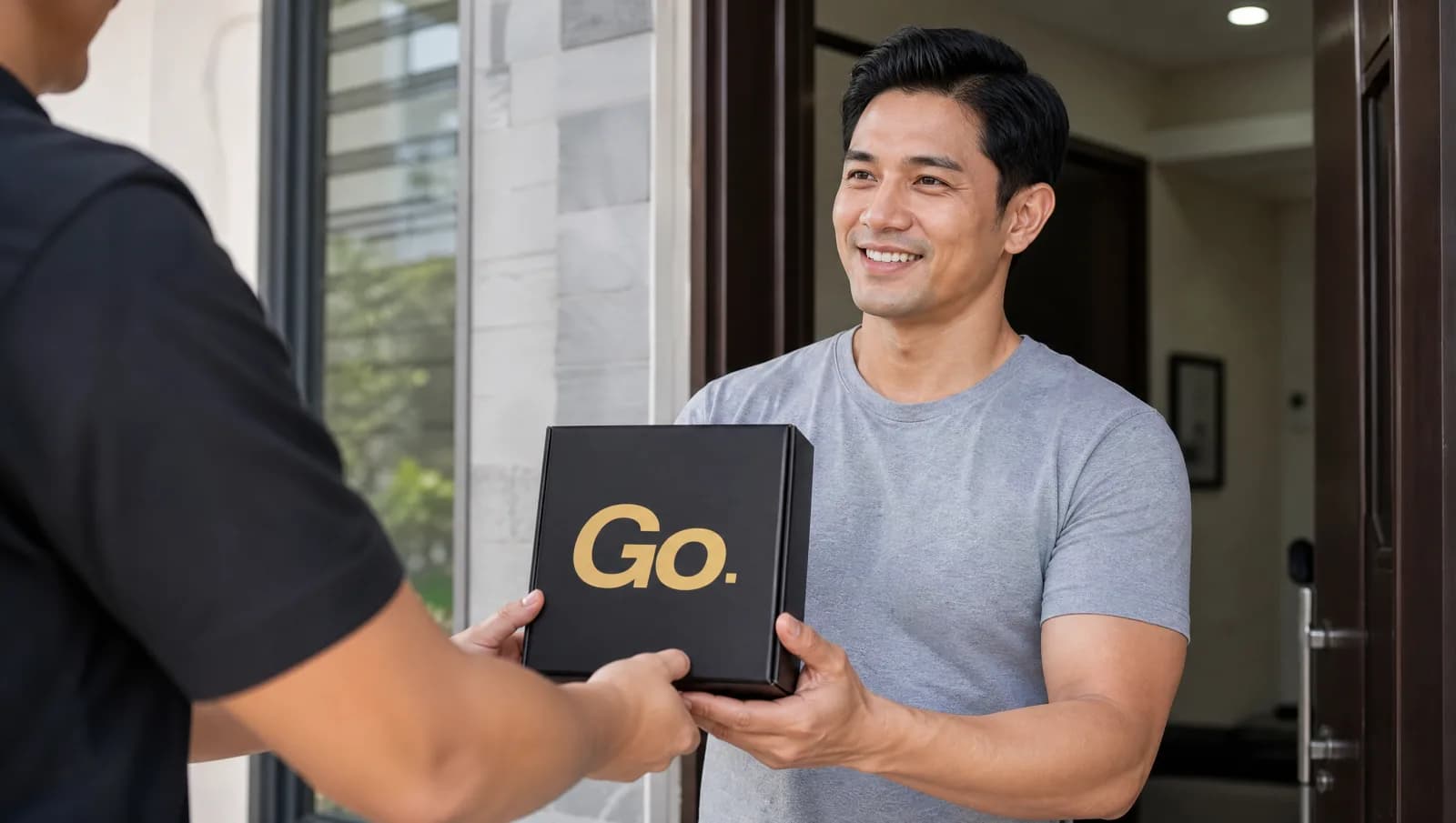 Filipino man receiving a discreet GoRocky Go box from a courier at his door