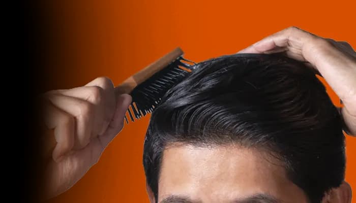 Person applying serum for hair regrowth